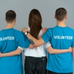 Man in Blue Crew Neck T-shirt Standing Beside Woman in White Sleeveless Shirt