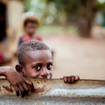 boy holding corrugated sheet